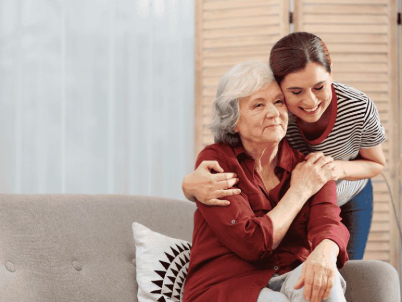 woman hugging senior loved one