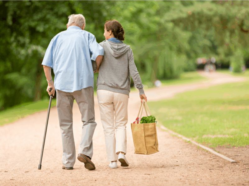 geriatric care manager on a walk with senior client
