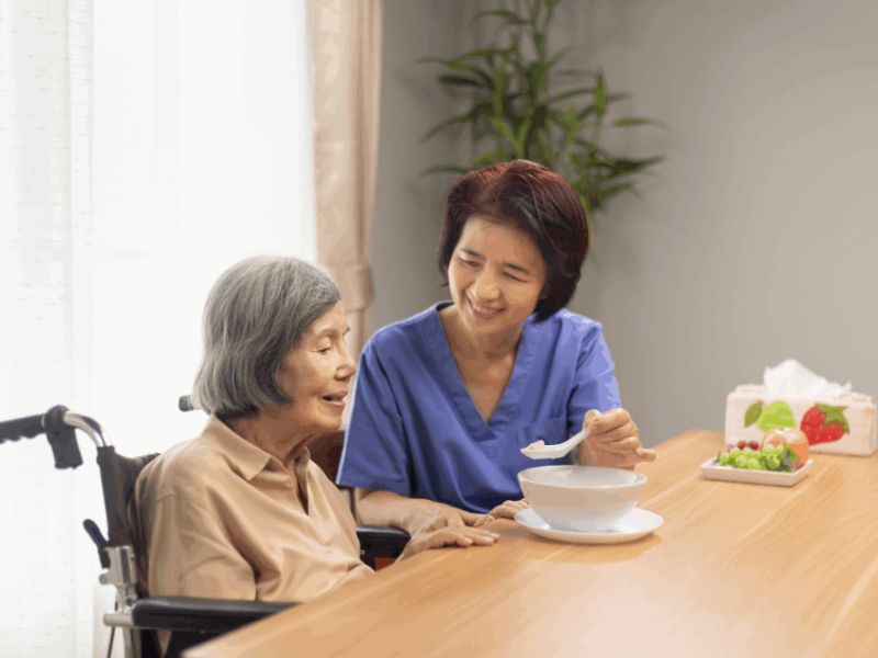 in-home caregiver serving elderly person