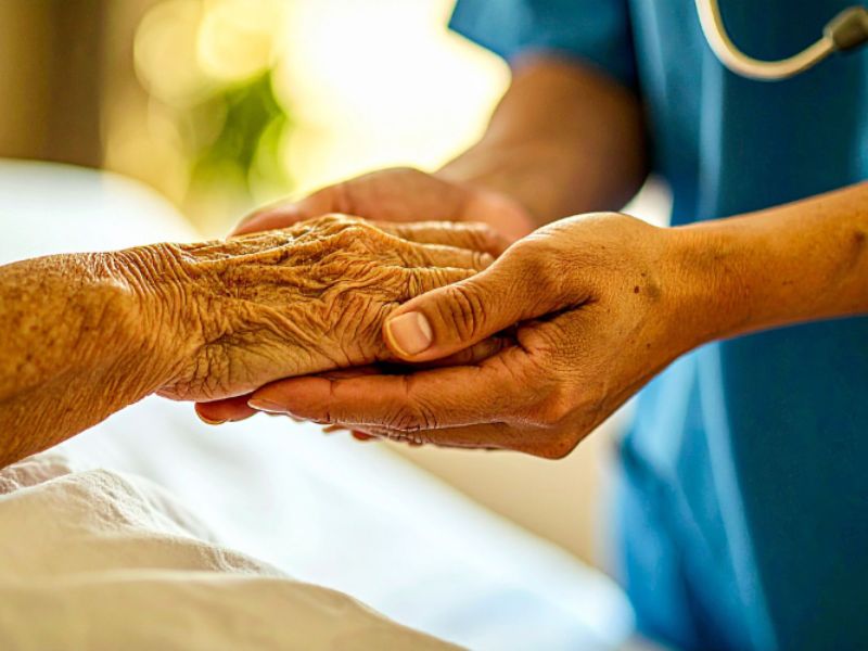 caregiver holding a senior's hand