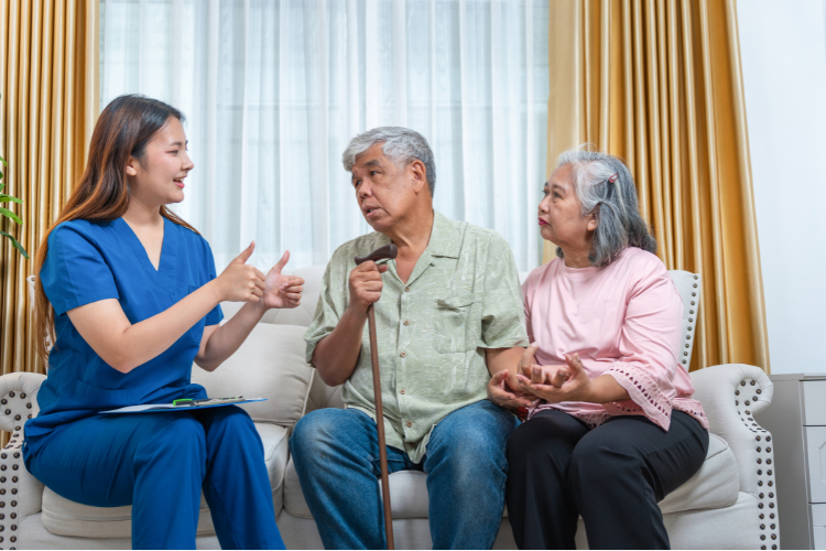 an elderly couple speaking with a geriatric care manager